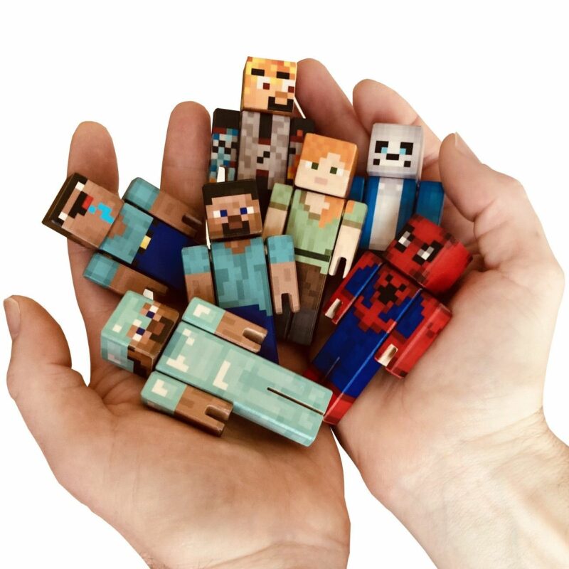 Seven colorful wooden Minecraft figures in the palm of hand.